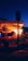 A cozy villa terrace at sunset with soft lighting and comfortable seating.