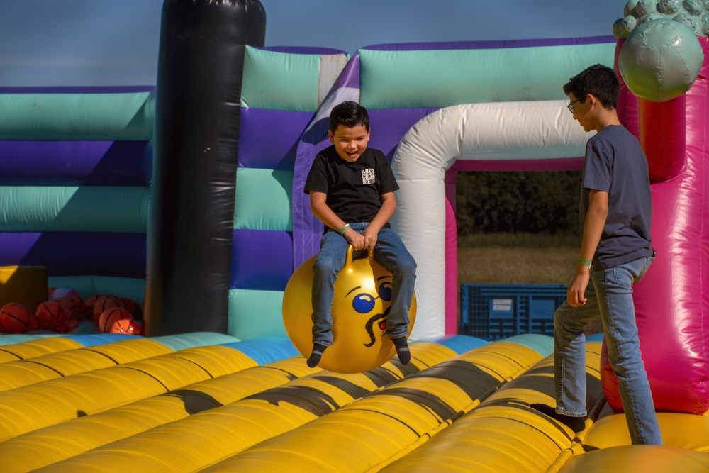 a couple of kids playing in a bouncy house