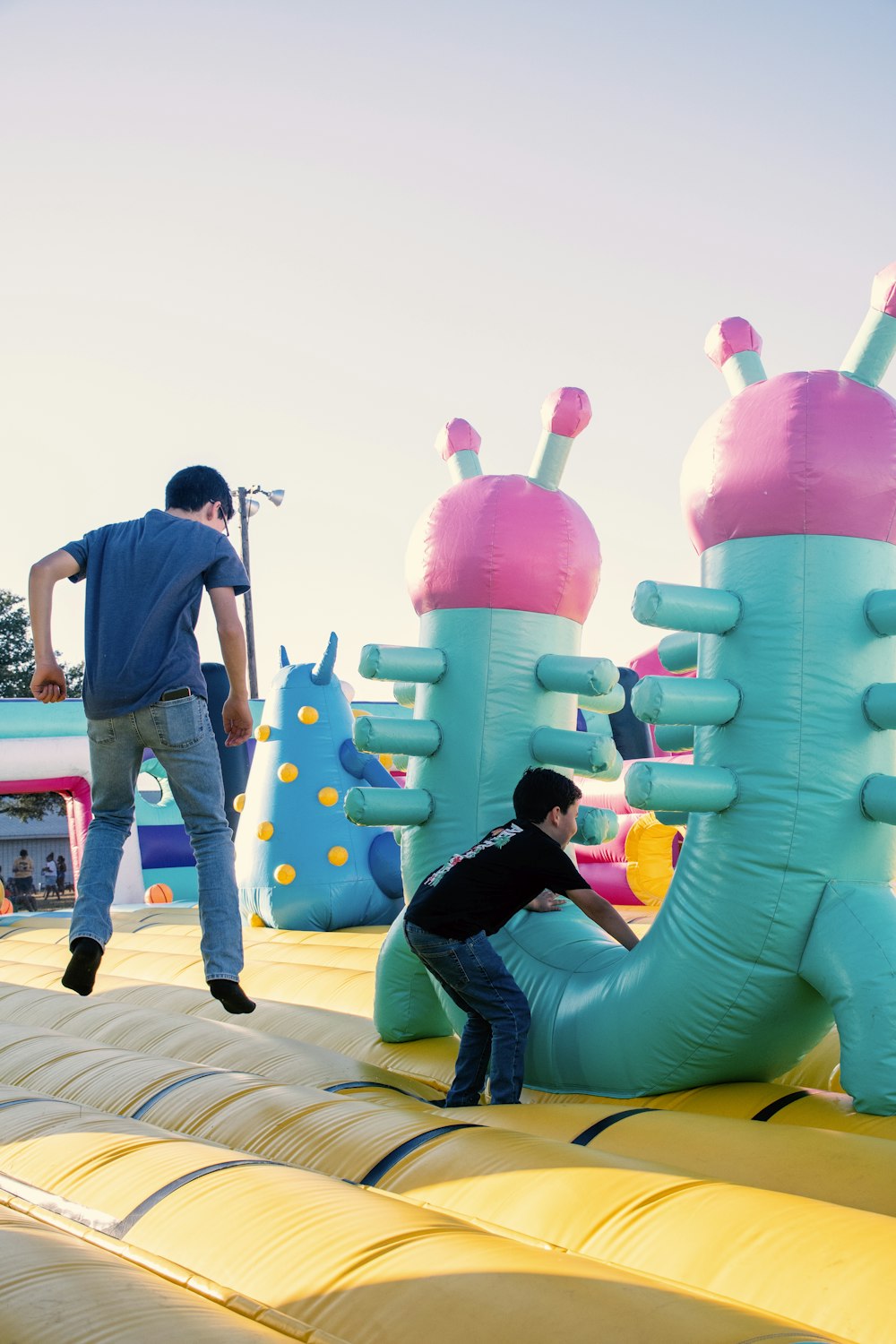 a man and a boy playing on a inflatable slide