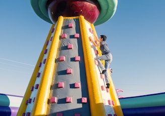 a man climbing up the side of a large inflatable structure