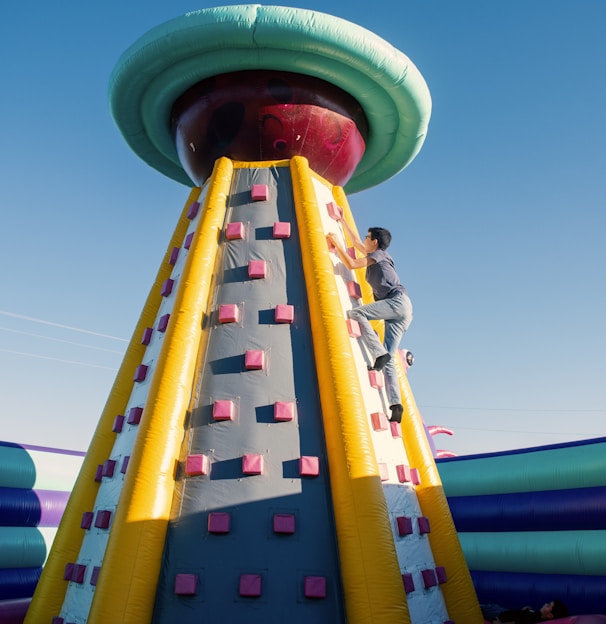 a man climbing up the side of a large inflatable structure