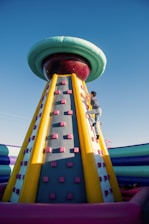 a man climbing up the side of a large inflatable structure