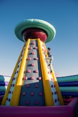 a man climbing up the side of a large inflatable structure