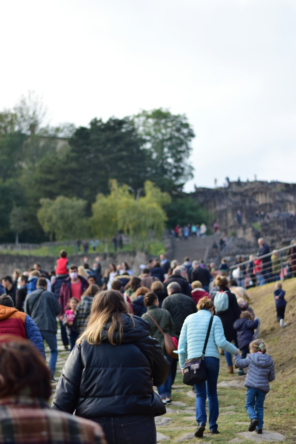 a large group of people walking up a hill