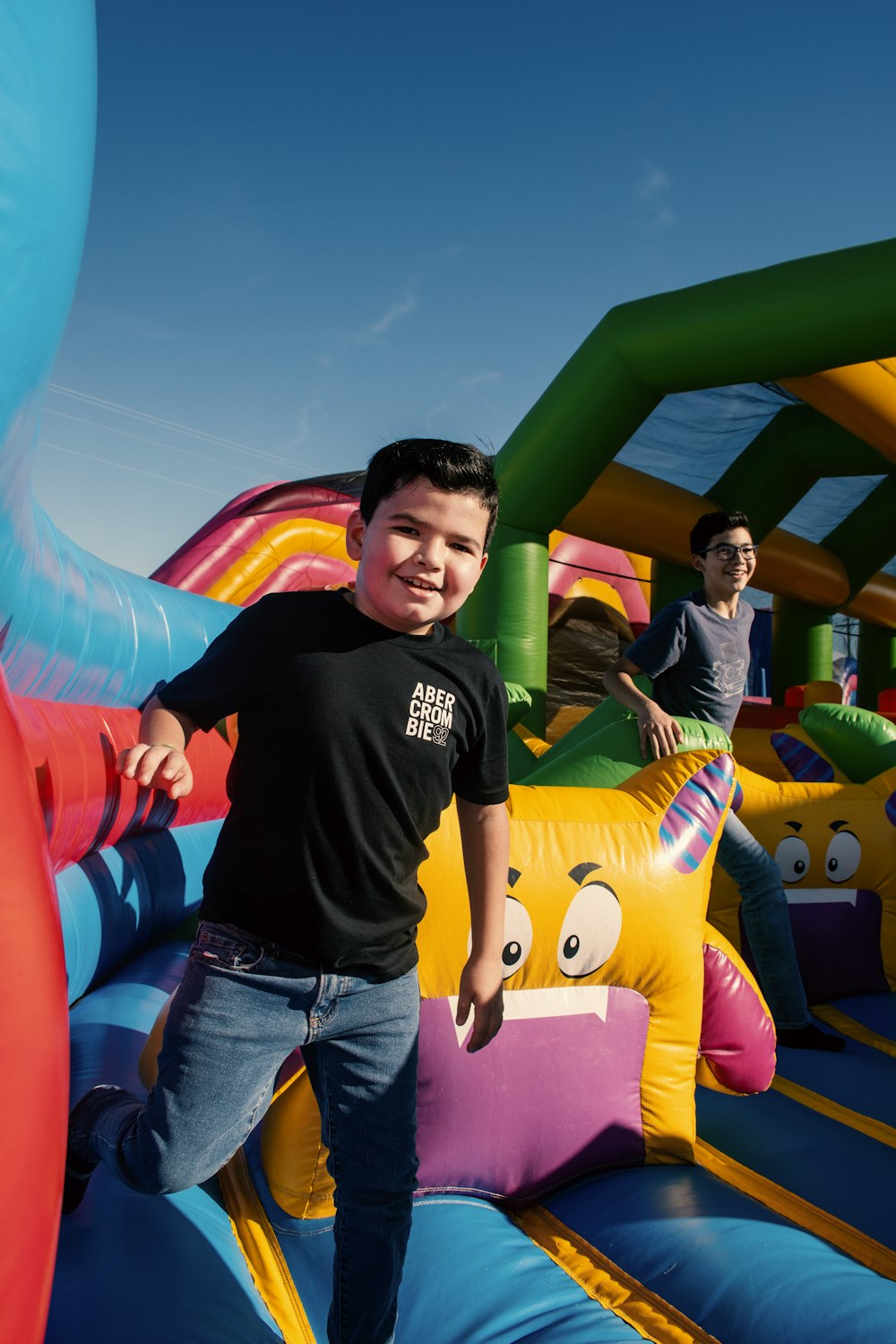 a young boy standing on top of a bouncy castle