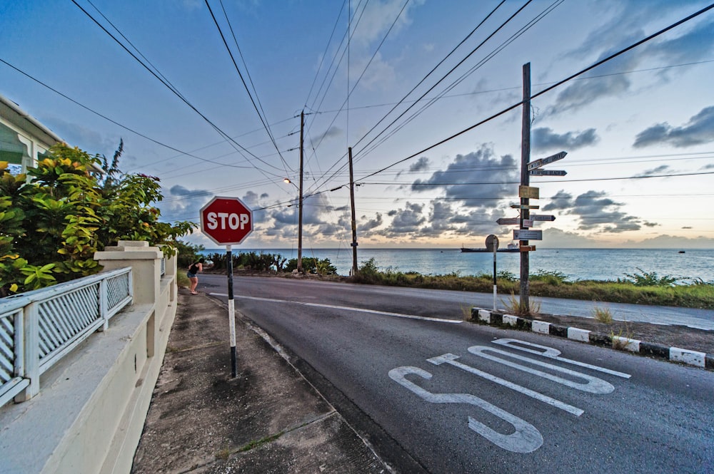 a red stop sign sitting on the side of a road