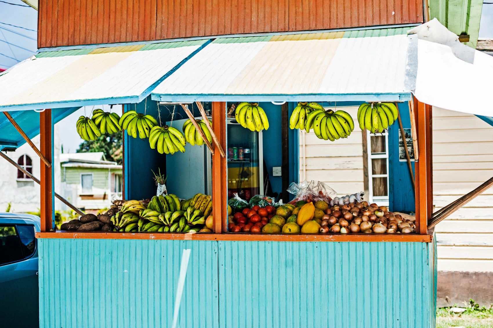 A colourful roadside fruit stand filled with local produce in Barbados