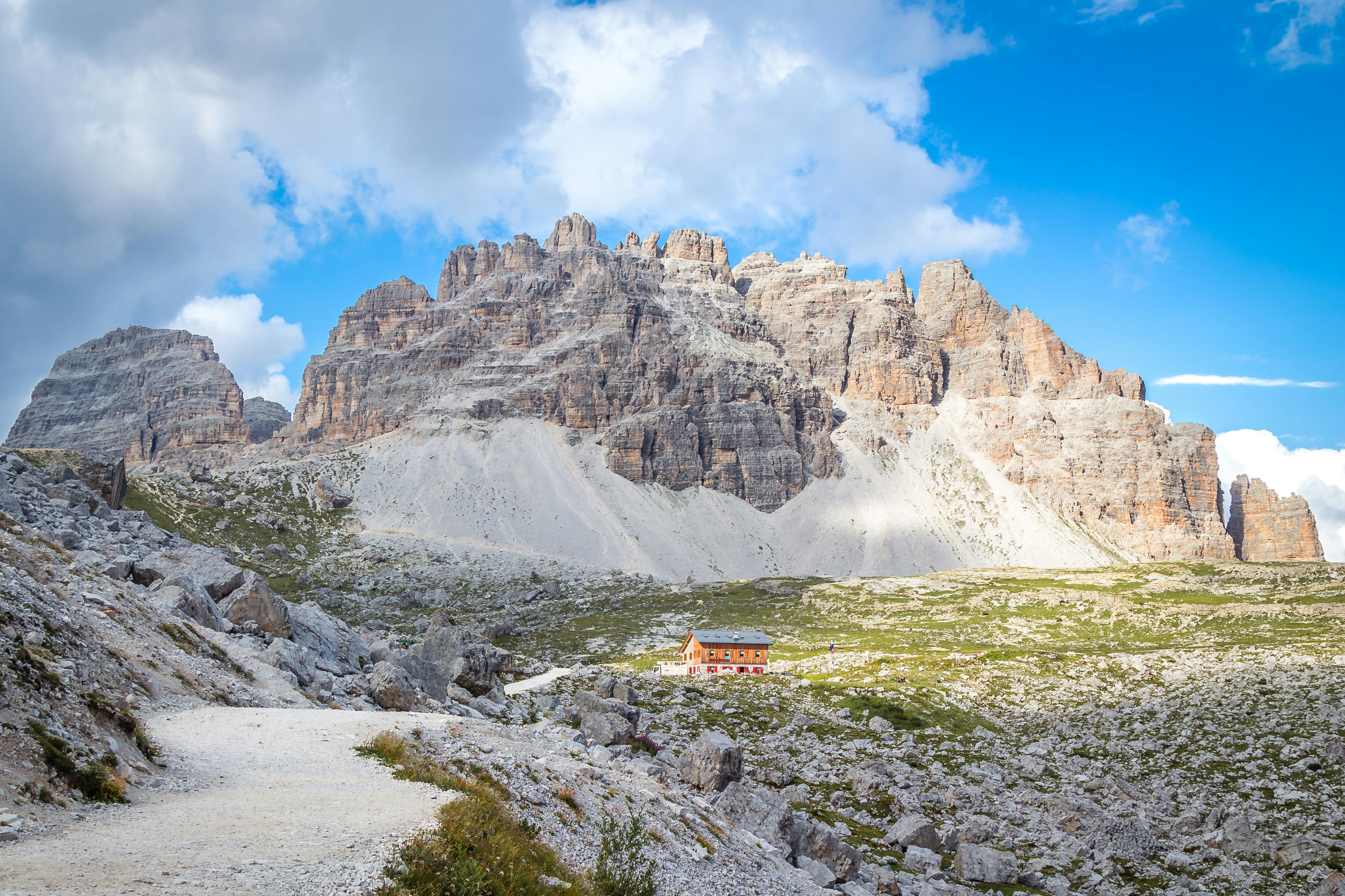 a small house in the middle of a mountain range
