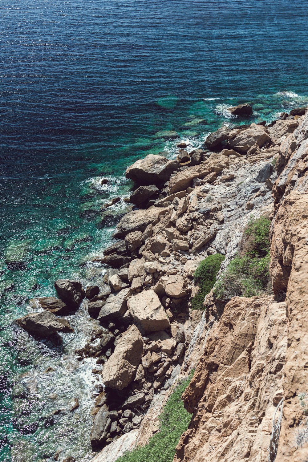 a man riding a surfboard on top of a rocky cliff