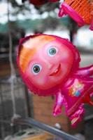 Creative balloon sculpture of a cartoon character smiling at a festive event.