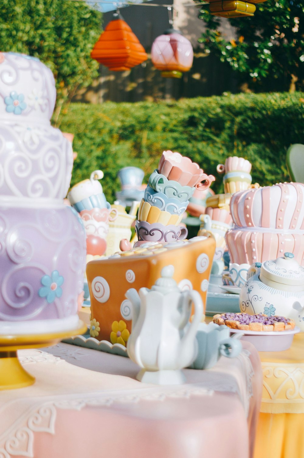 a table topped with lots of colorful cakes