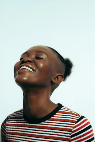 a woman with her eyes closed and a smile on her face