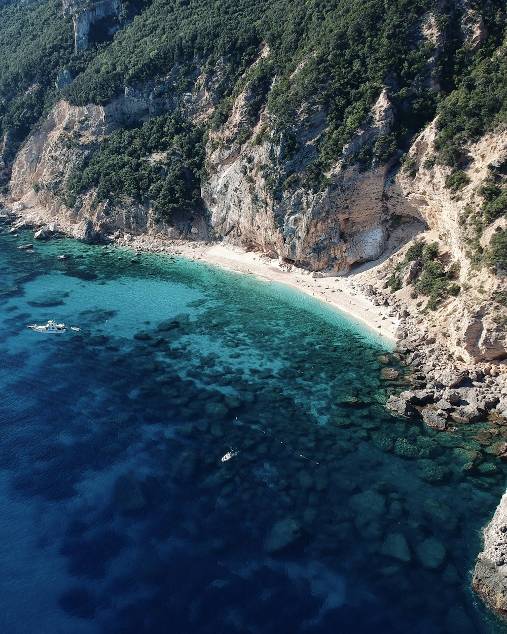 an aerial view of a beach near a cliff