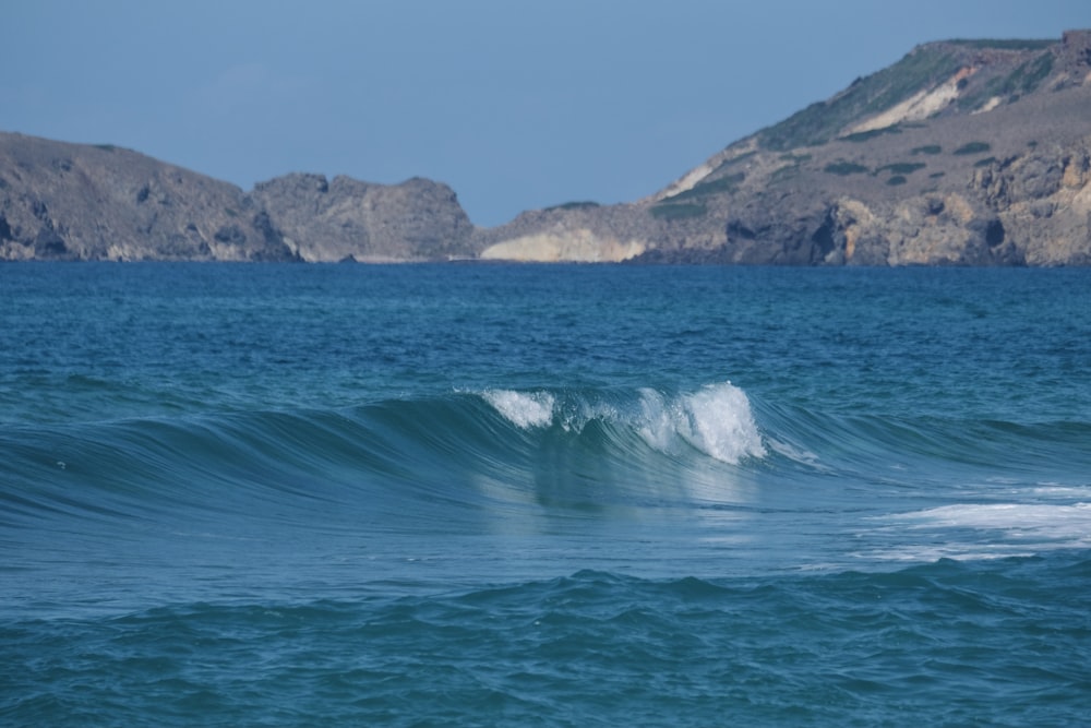 a person riding a wave on top of a surfboard