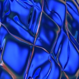 Abstract geometric shapes illuminated in metallic blue tones conveying innovation.