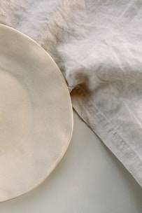 a white plate sitting on top of a white table