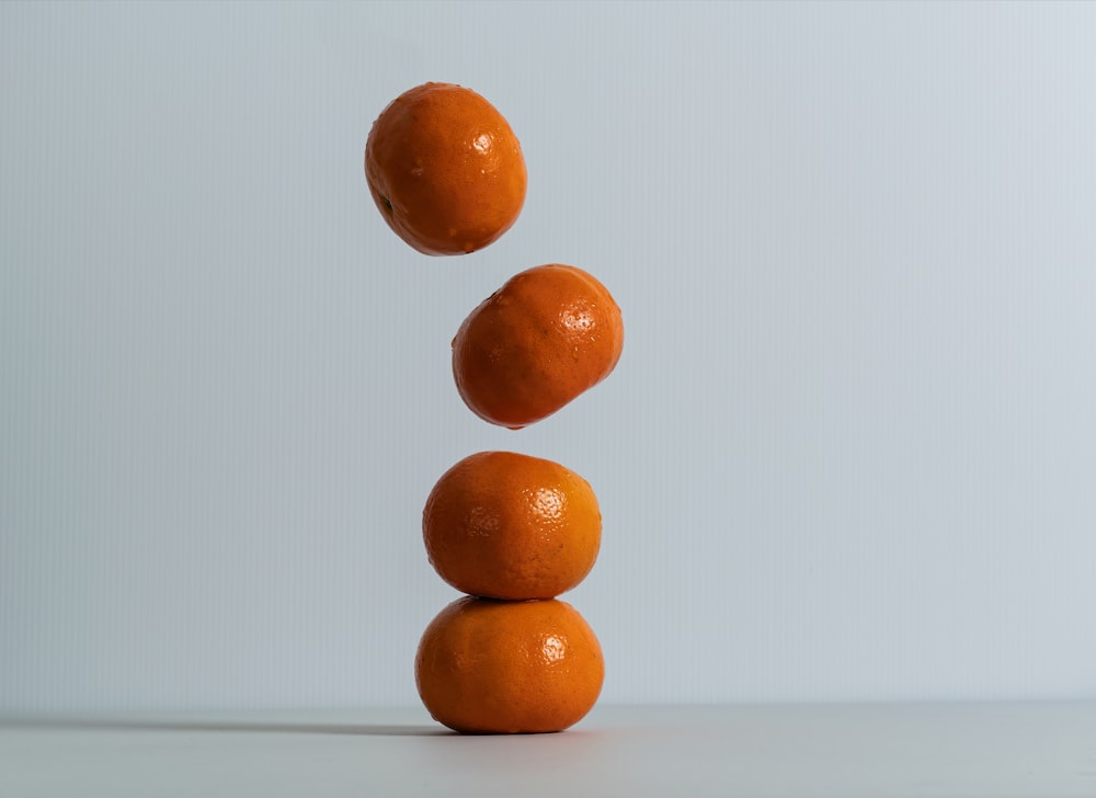 a stack of three oranges sitting on top of each other