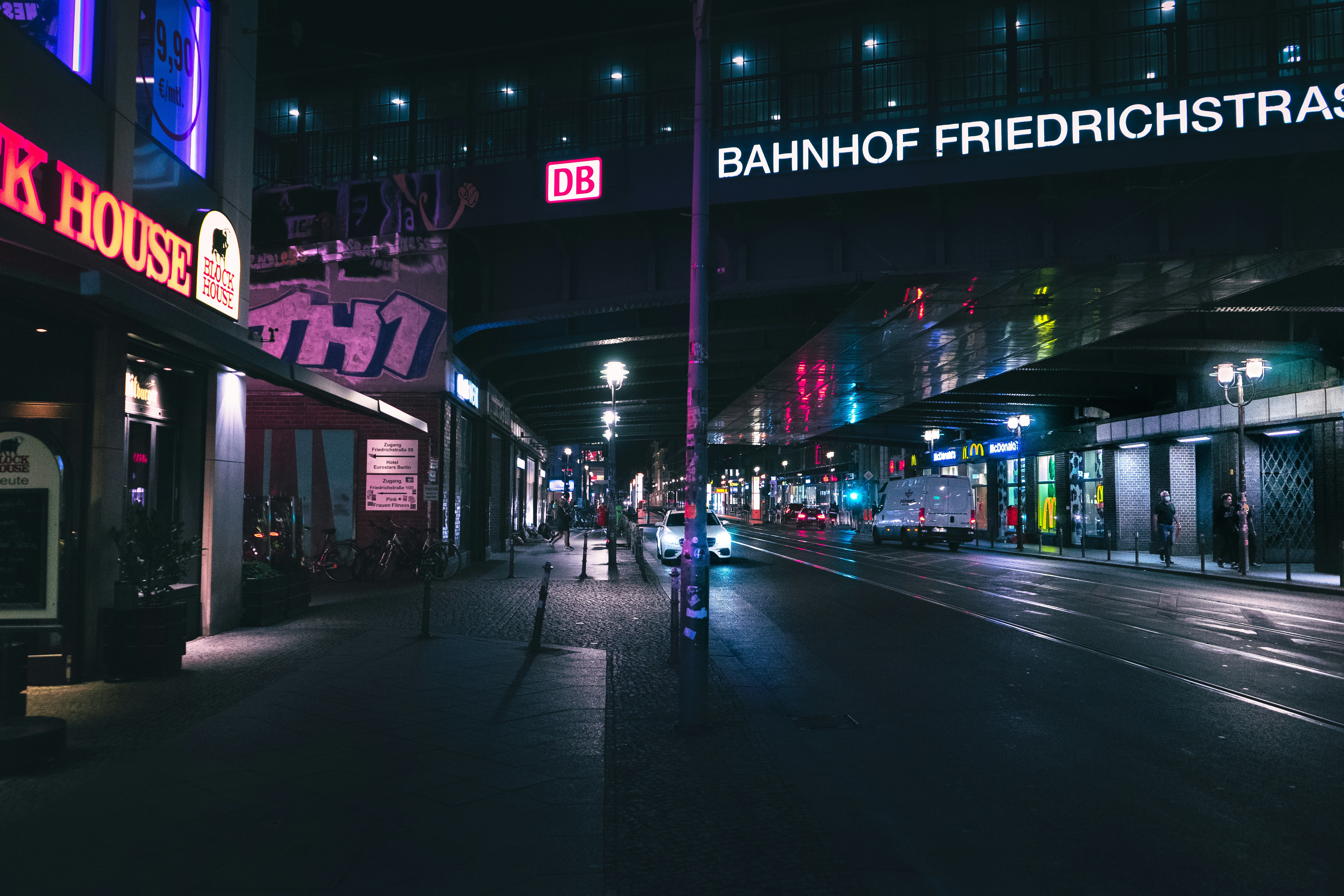 a city street at night with neon lights