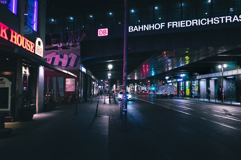 a city street at night with neon lights