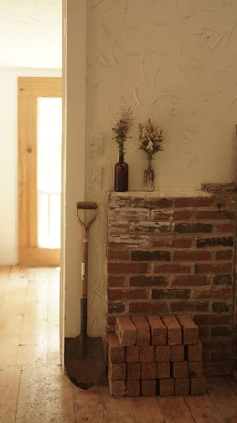a brick fireplace with a shovel on top of it