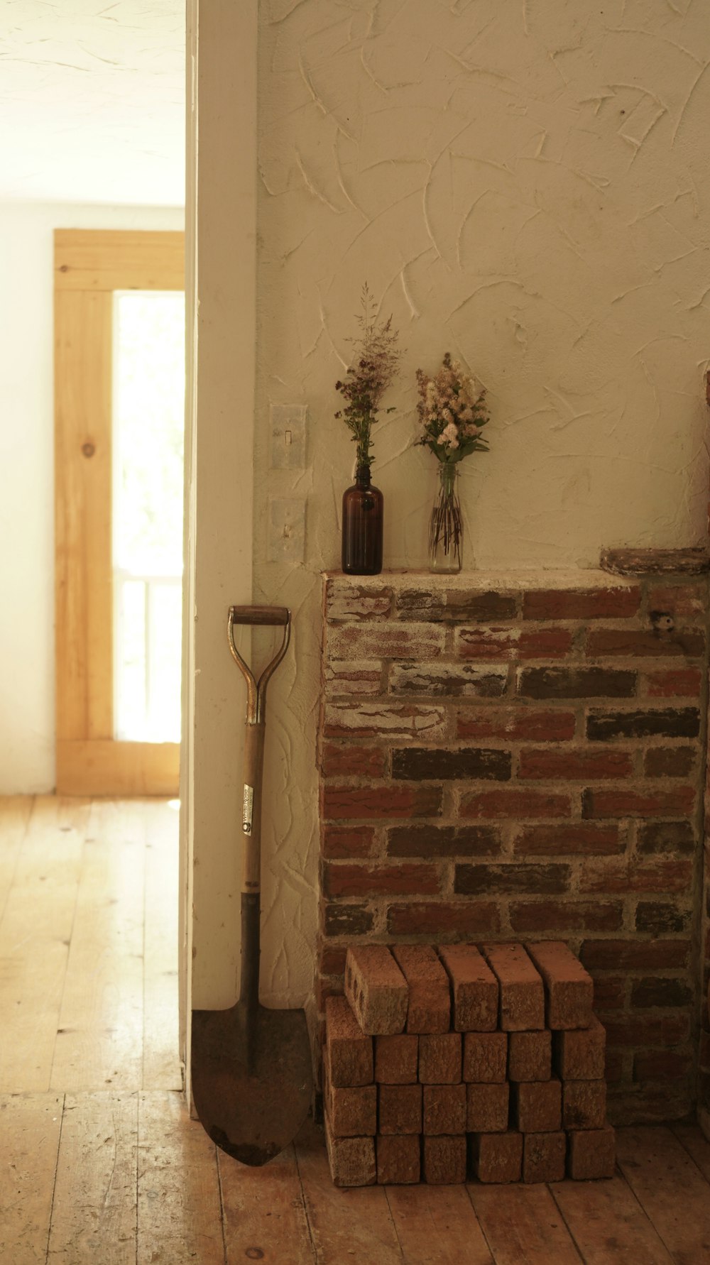 a brick fireplace with a shovel on top of it