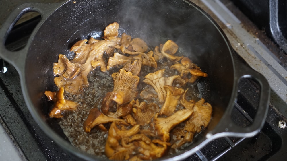 a frying pan filled with food on top of a stove