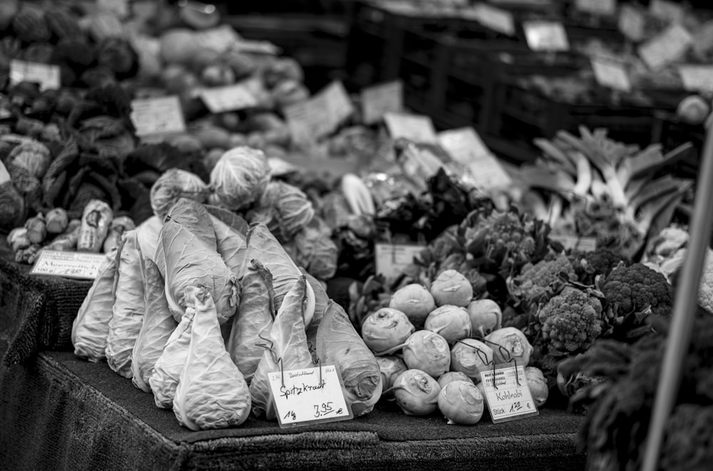 a black and white photo of produce at a market