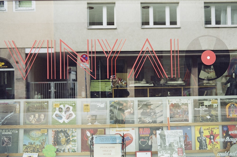 a store front with a lot of posters behind it