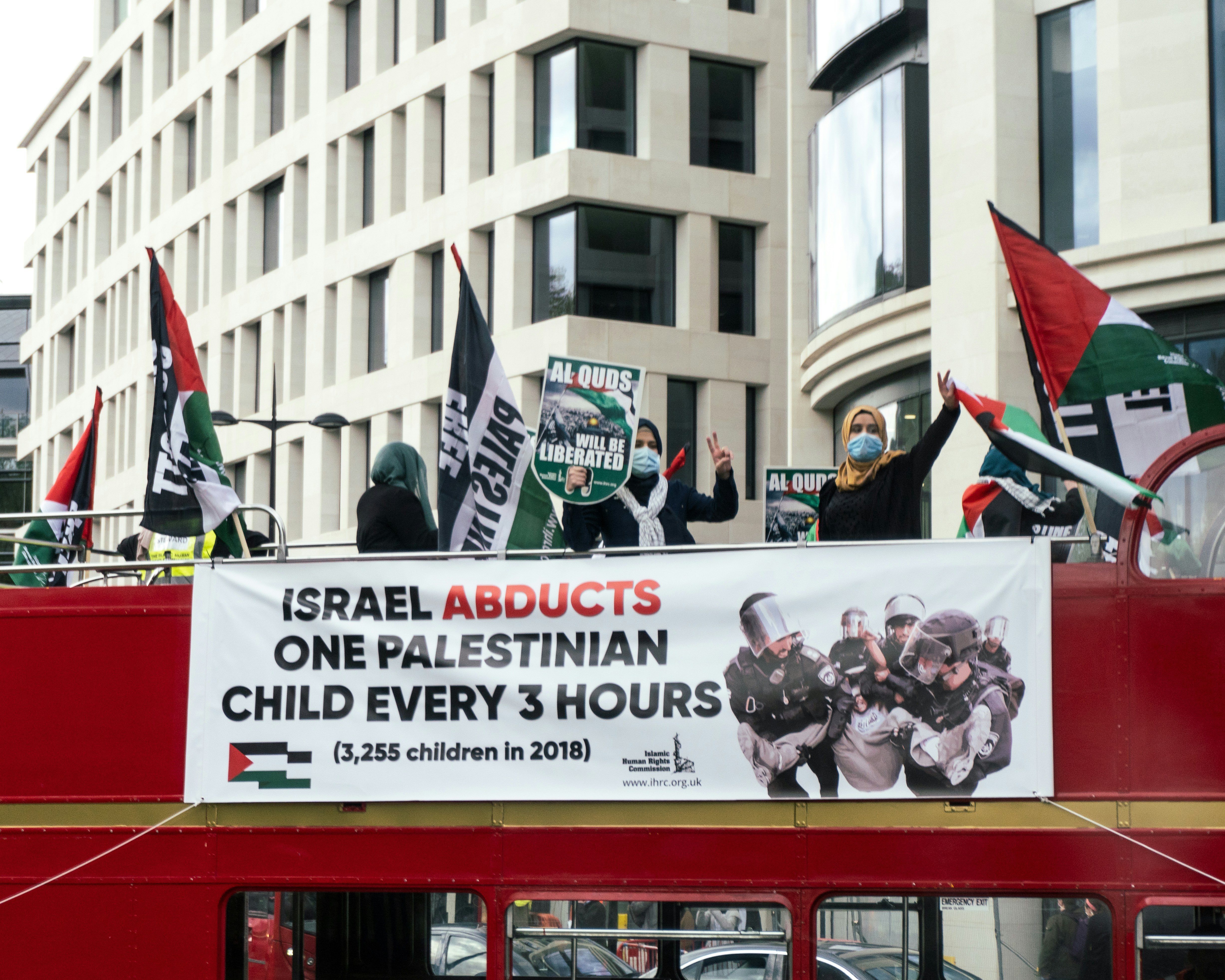 a red double decker bus filled with people