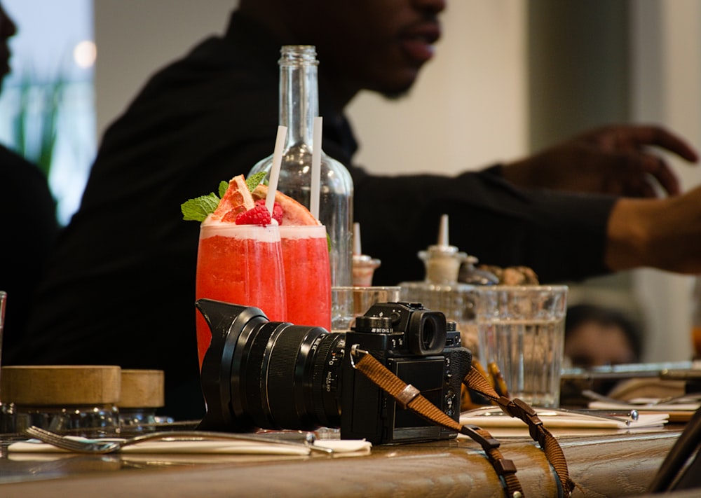 a camera and some drinks on a table
