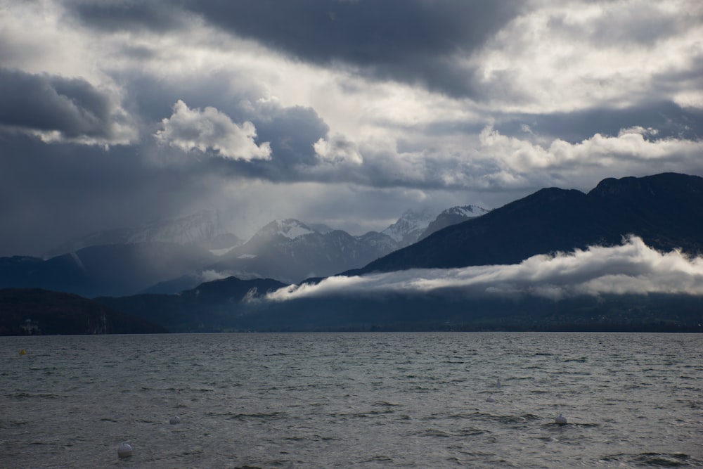 a large body of water with mountains in the background