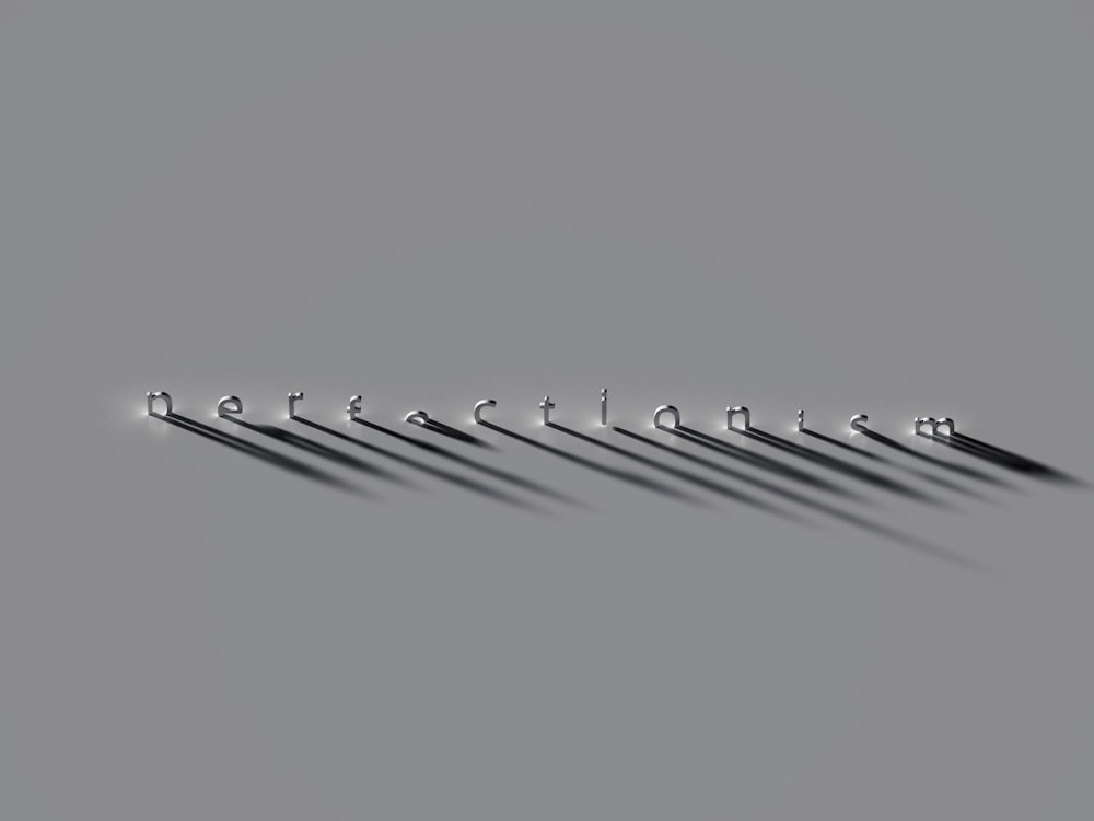 a row of metal hooks on a gray background