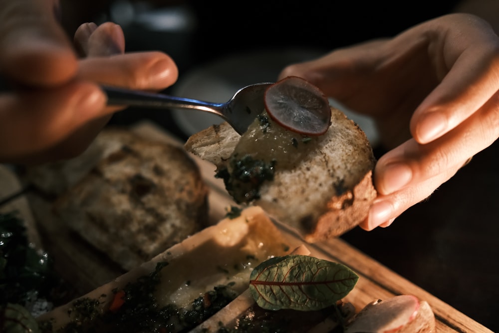 a close up of a person cutting a sandwich