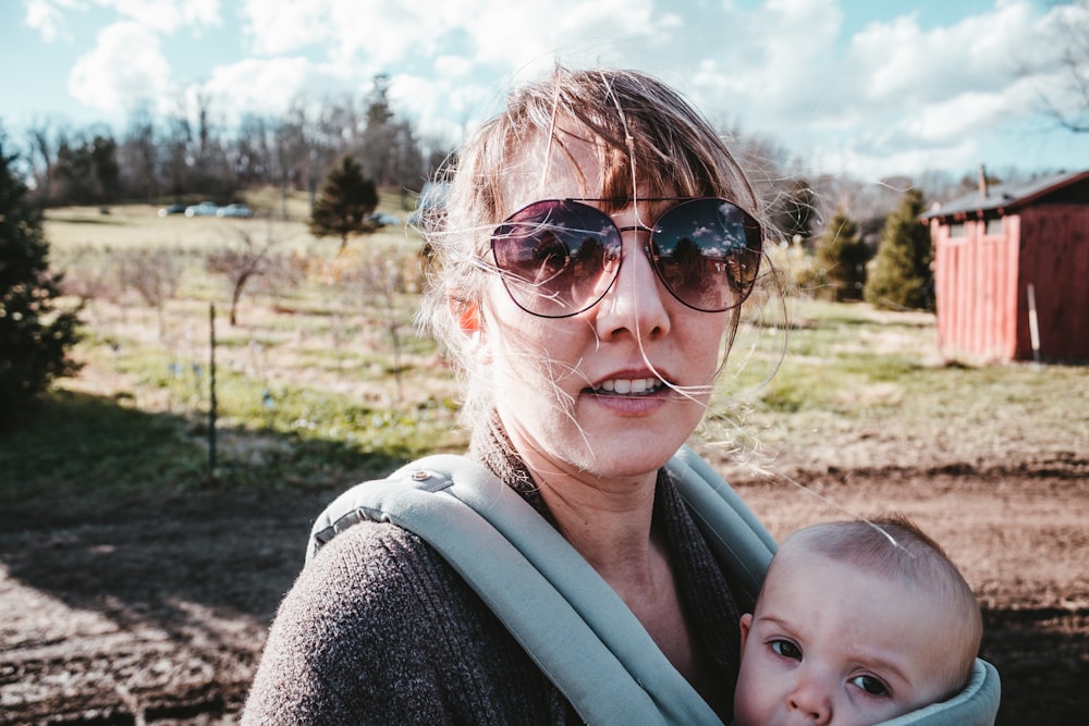 a woman holding a baby in a sling