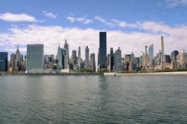 a large body of water with a city in the background