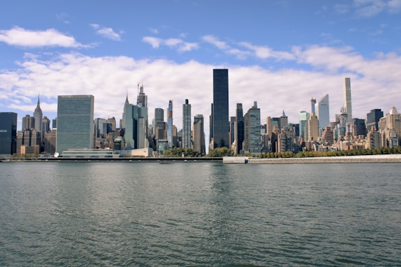 a large body of water with a city in the background