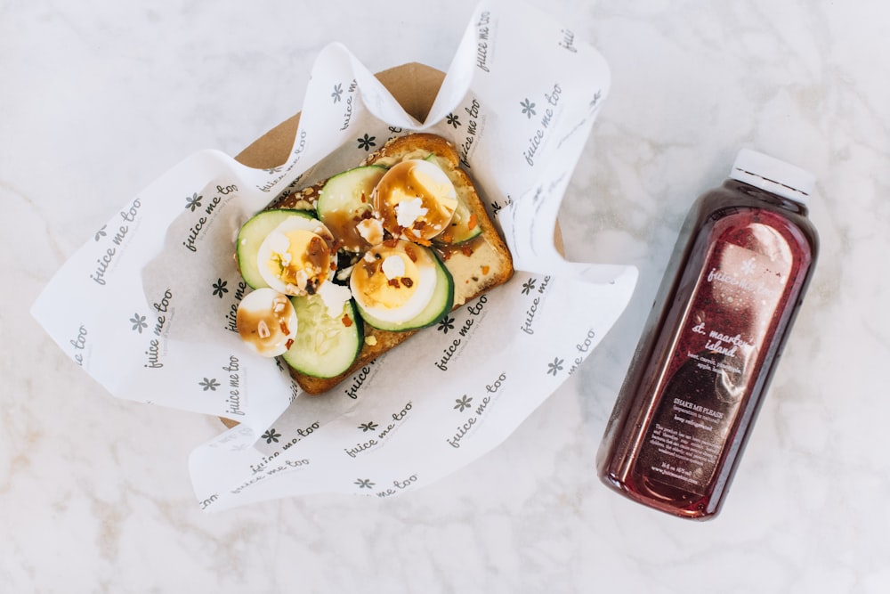 a sandwich and a bottle of ketchup on a table