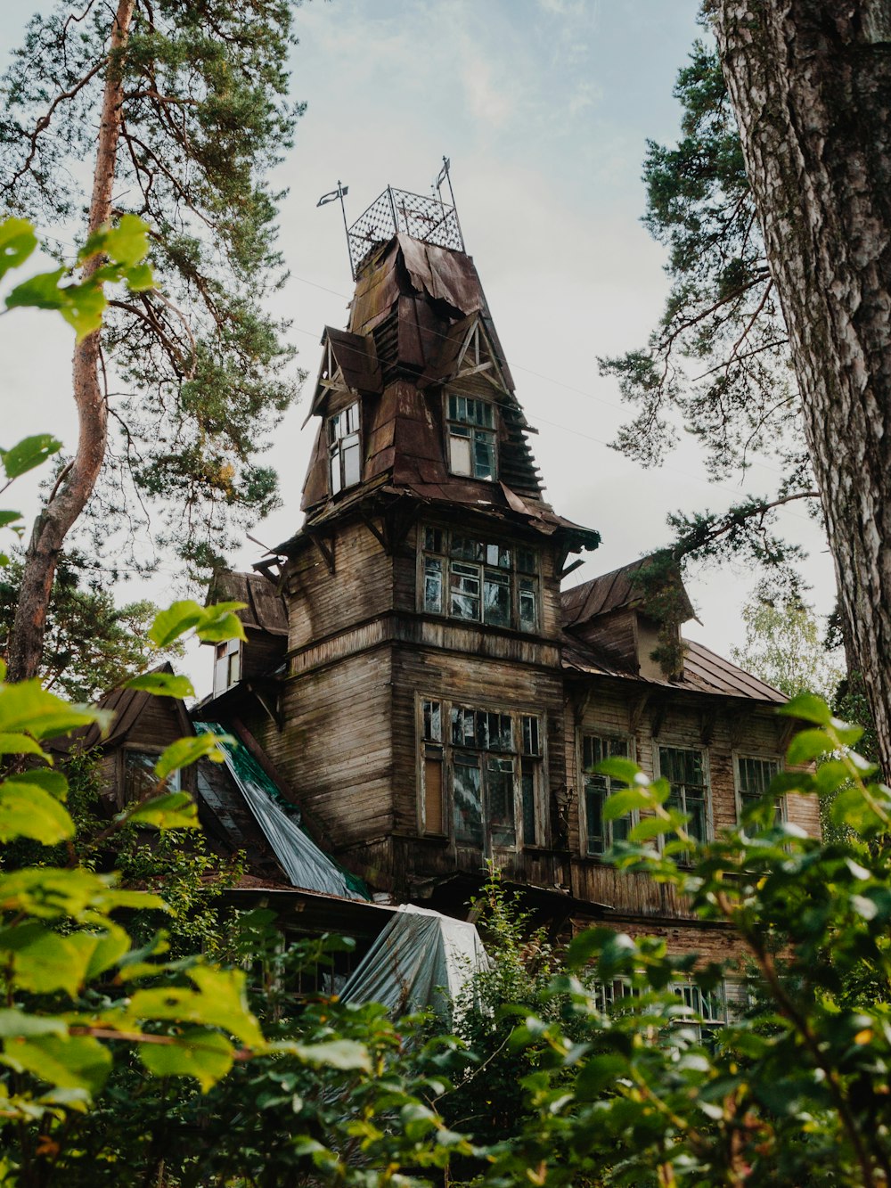 a large wooden house with a tower and windows