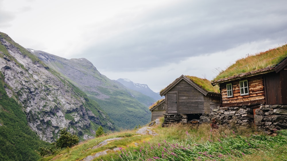 a house with a grass roof on top of a mountain