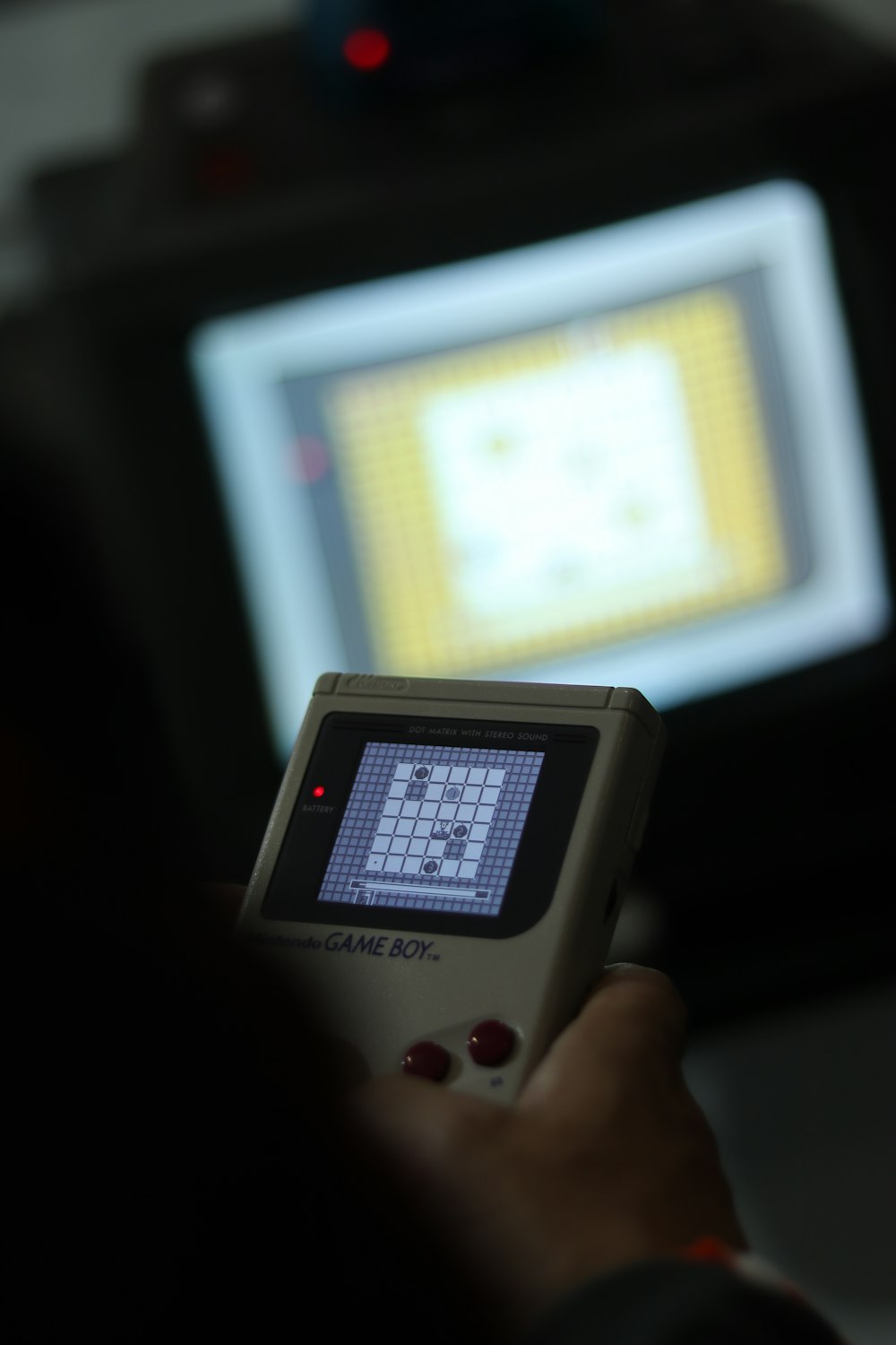 a person holding a game controller in front of a tv