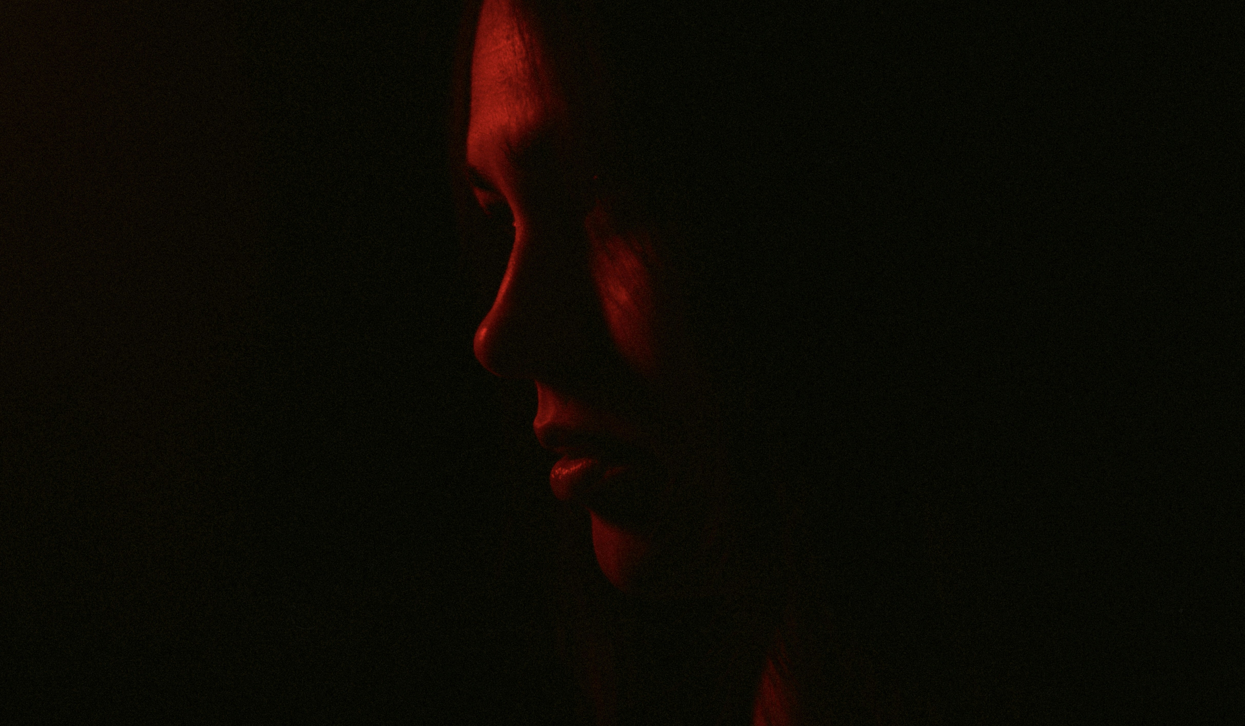 A woman in the dark with a red light on her face photo – Free Sexy ...