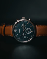 a close up of a watch on a black surface