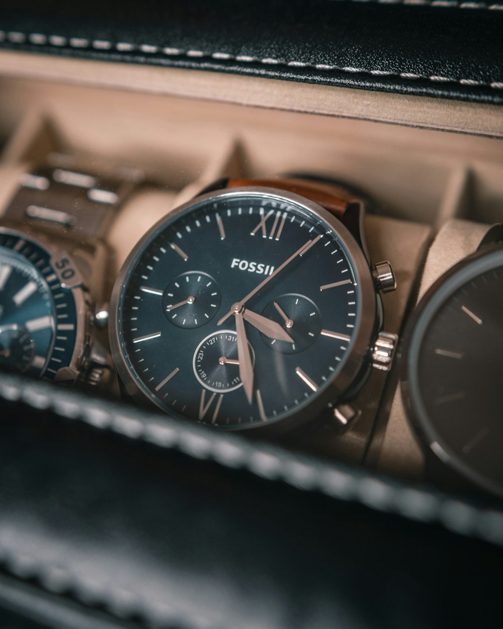 a couple of watches sitting inside of a case