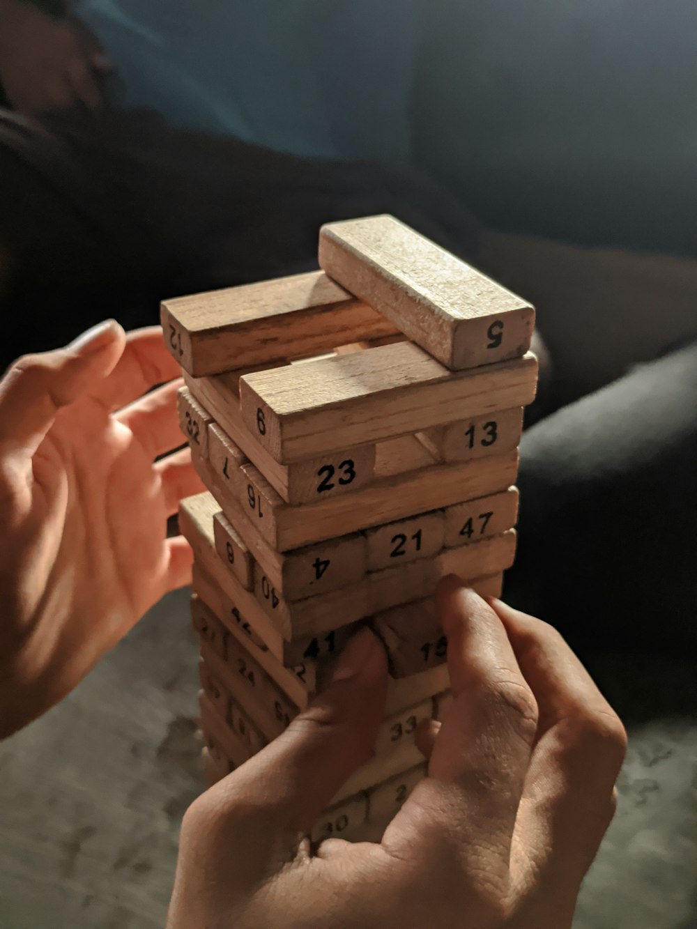 a person holding a stack of wooden blocks