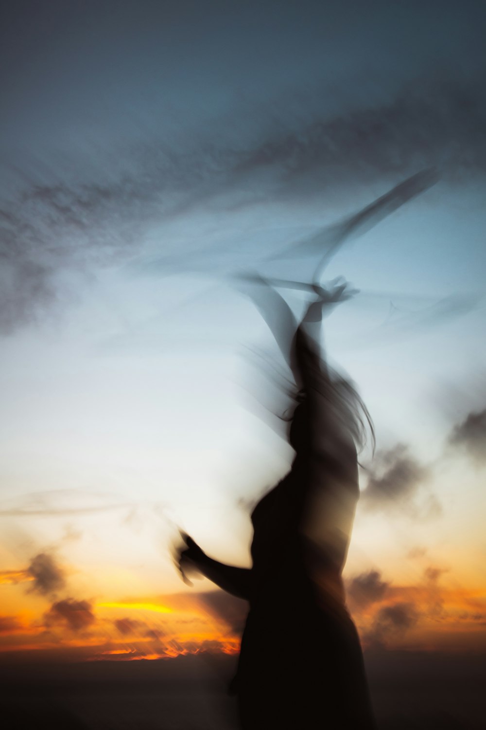 a blurry photo of a person holding a kite