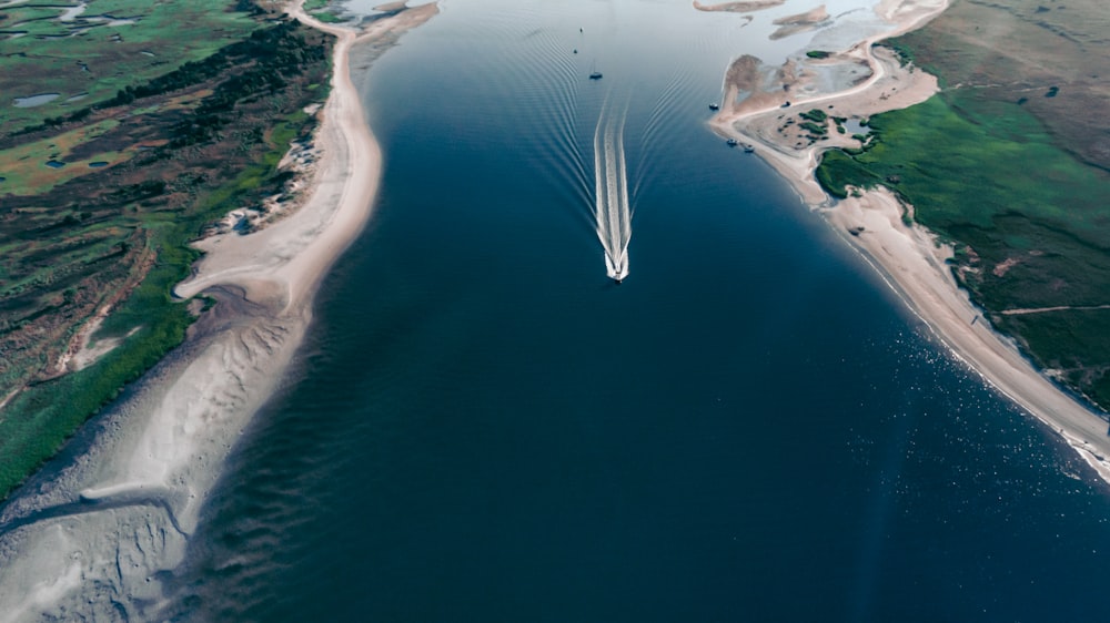 an aerial view of a boat in a body of water