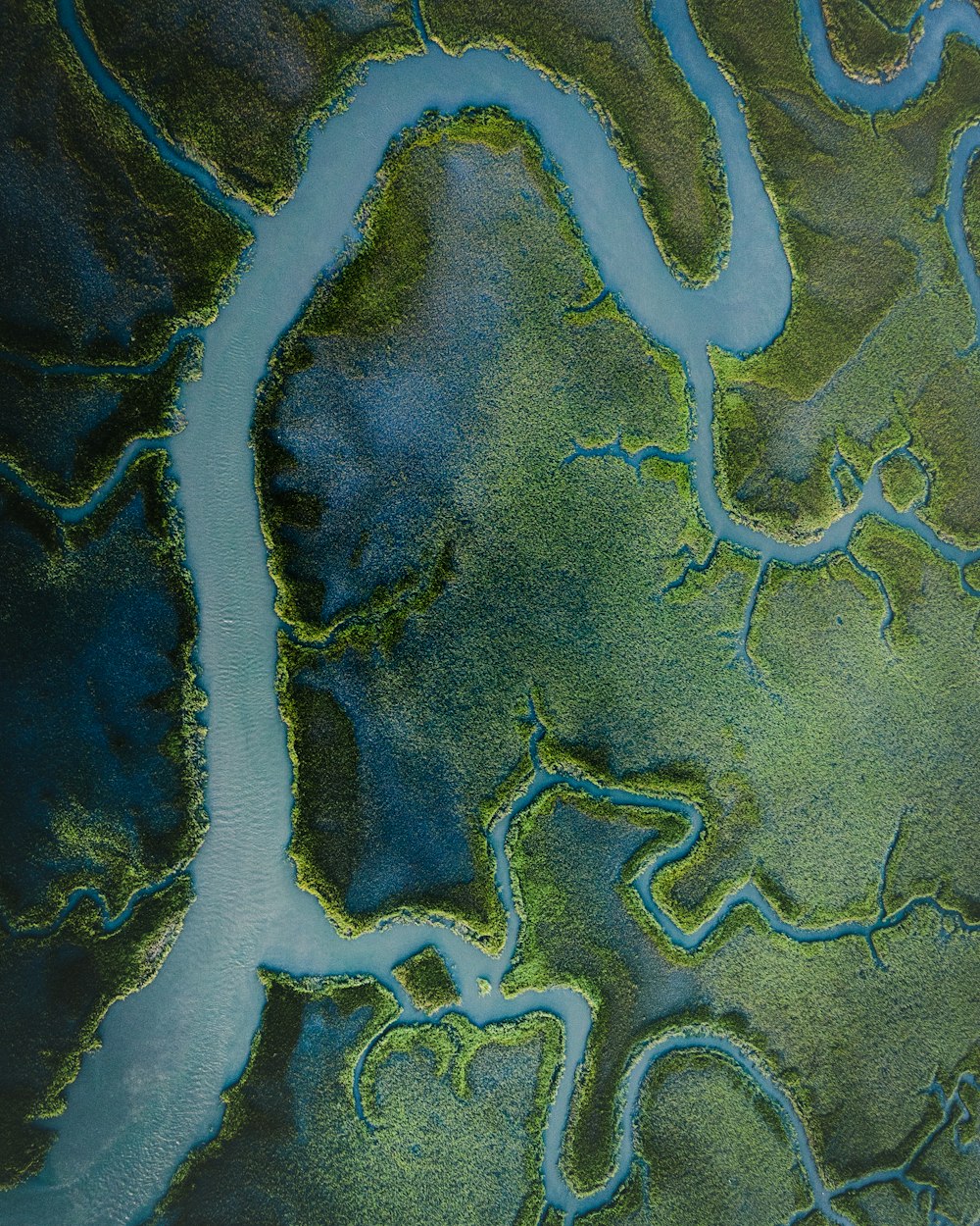 an aerial view of a river and land