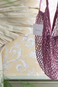 Close-up of a pink and purple themed reservation tag on anime merchandise.