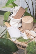 a bamboo table topped with wooden utensils and a bag