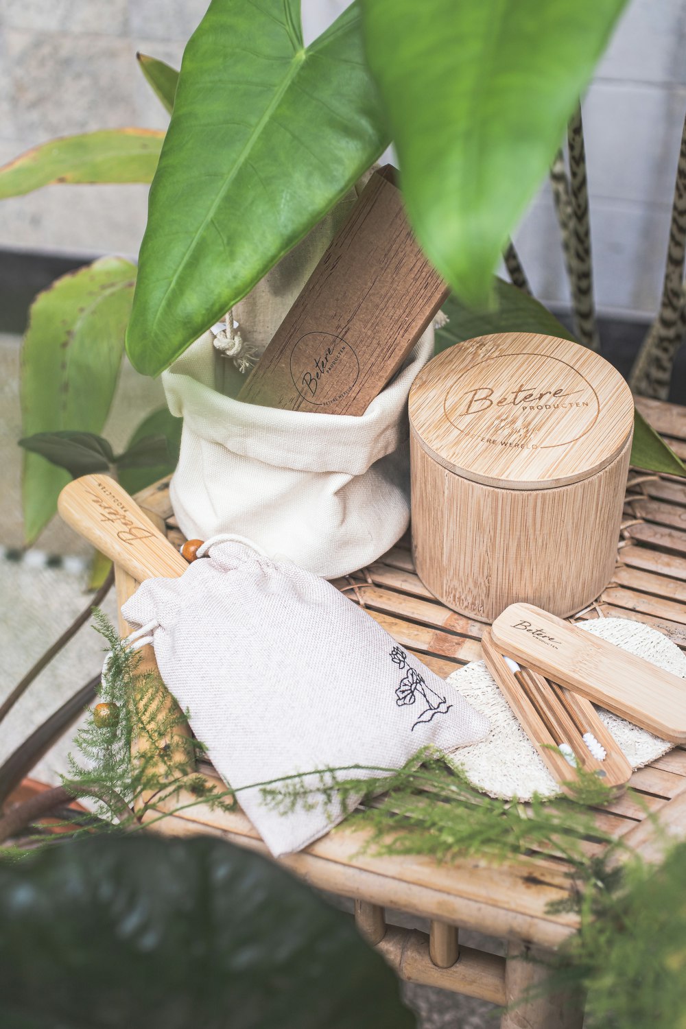 a bamboo table topped with a potted plant and wooden utensils